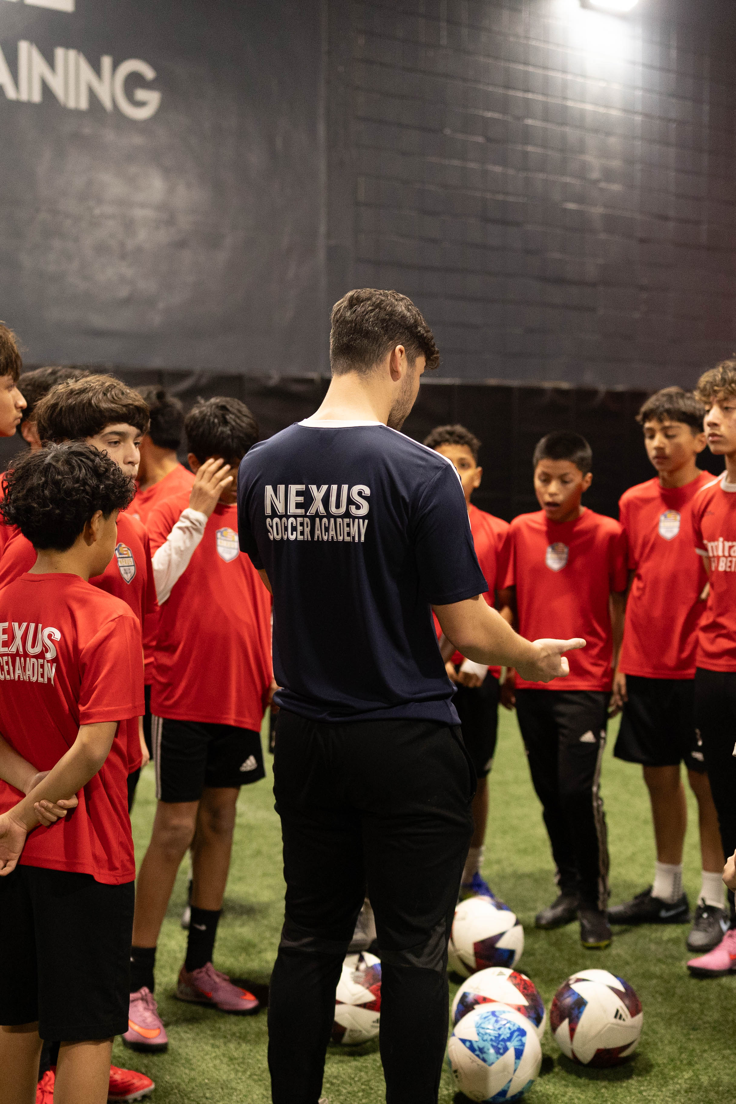 Coach Cufi instructing Nexus Soccer Academy players